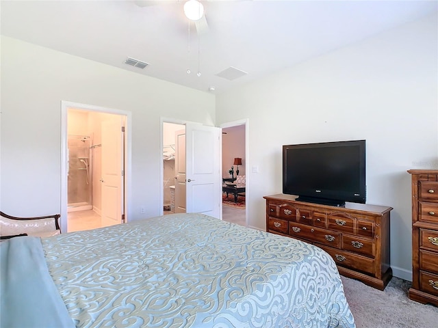 bedroom featuring light carpet, visible vents, and ensuite bathroom