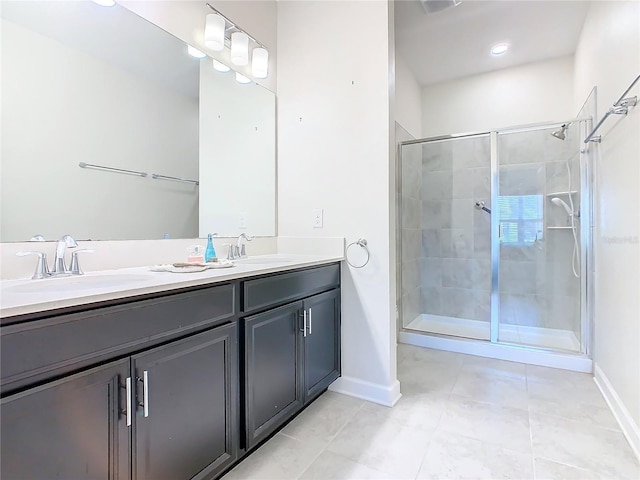 bathroom featuring baseboards, double vanity, a sink, and a shower stall