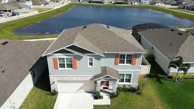 birds eye view of property featuring a water view and a residential view