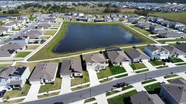 drone / aerial view featuring a residential view and a water view