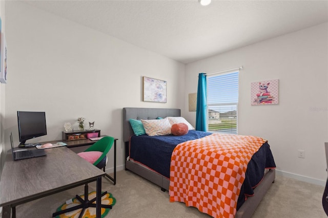 bedroom with baseboards and light colored carpet