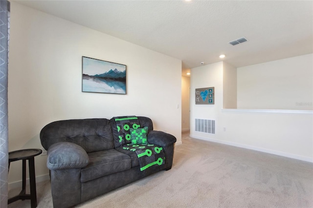 living area with recessed lighting, baseboards, visible vents, and light colored carpet