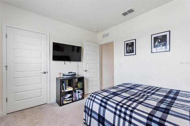 bedroom with carpet floors and visible vents