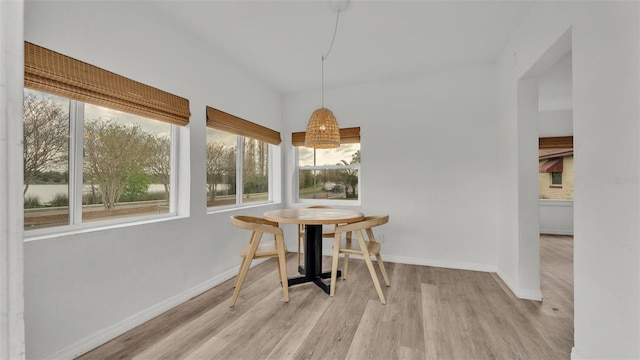 dining area featuring wood finished floors and baseboards