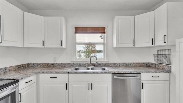 kitchen with stainless steel appliances, white cabinets, and a sink