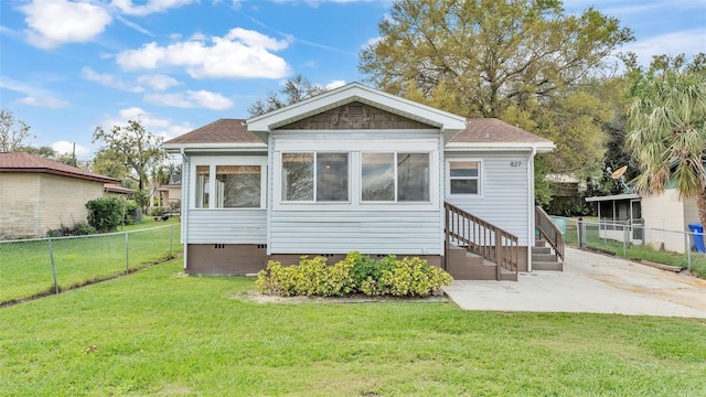 back of house with entry steps, crawl space, a lawn, and fence private yard