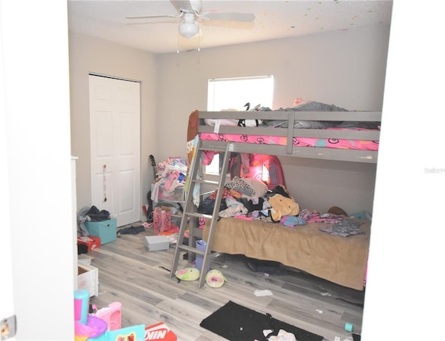 bedroom with light wood-type flooring and a ceiling fan