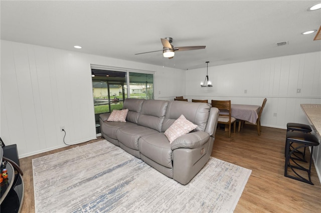 living room featuring ceiling fan, light wood-style flooring, visible vents, and recessed lighting