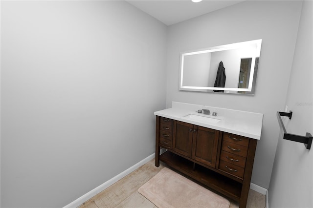 bathroom with baseboards and vanity