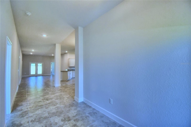 corridor with french doors and baseboards