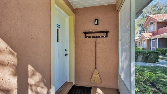 property entrance with stucco siding