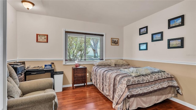 bedroom featuring baseboards and wood finished floors