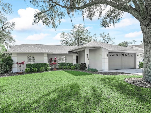 ranch-style home with a garage, a front yard, driveway, and stucco siding