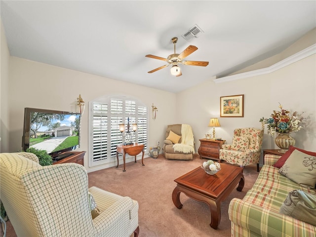 living area with carpet floors, visible vents, vaulted ceiling, and a ceiling fan