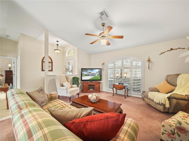 living room with lofted ceiling, light carpet, ceiling fan, and visible vents