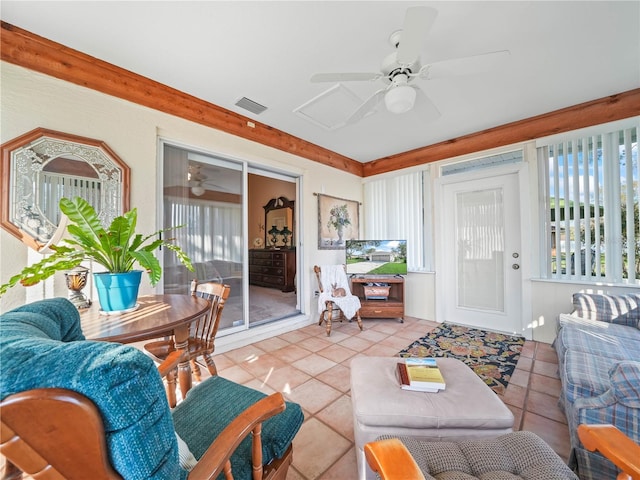 living room with light tile patterned floors, visible vents, and a ceiling fan