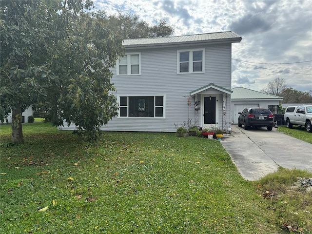 traditional home featuring driveway, metal roof, and a front yard