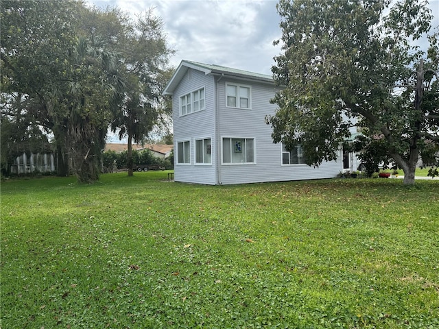 view of side of home featuring a lawn