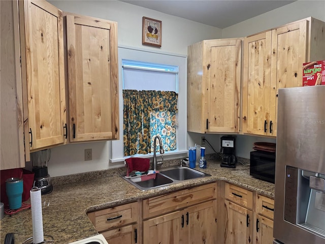 kitchen with stainless steel fridge, a sink, and light brown cabinetry