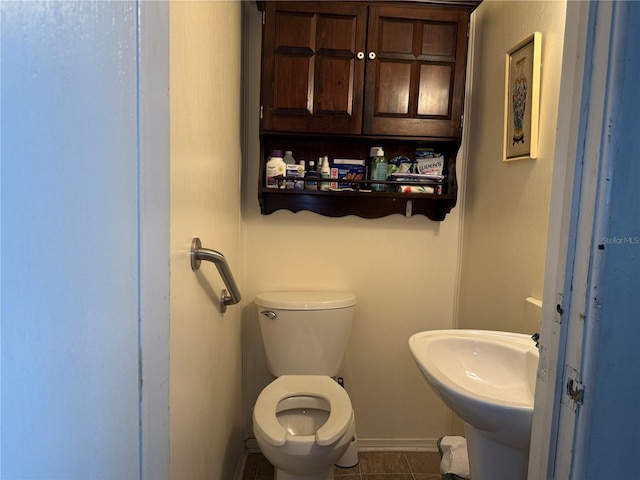 bathroom featuring toilet and tile patterned floors