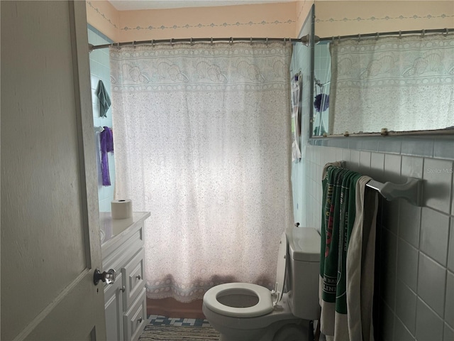 full bath featuring toilet, shower / tub combo, and tile walls