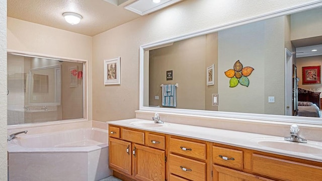 ensuite bathroom featuring double vanity, a garden tub, a sink, and ensuite bathroom