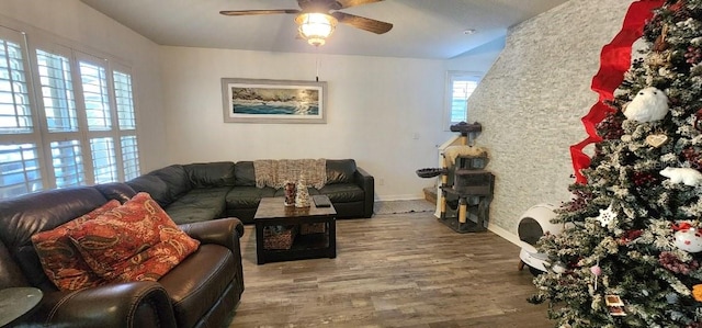 living room featuring ceiling fan, baseboards, and wood finished floors