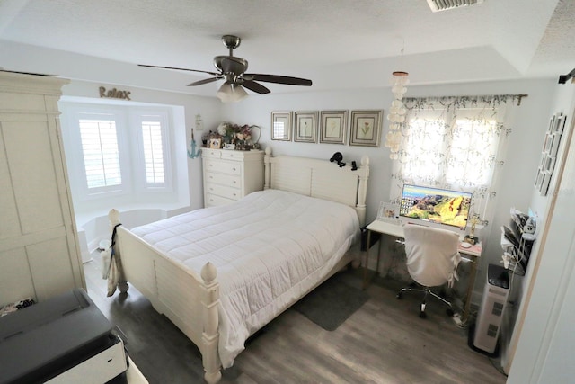 bedroom featuring visible vents, ceiling fan, and wood finished floors