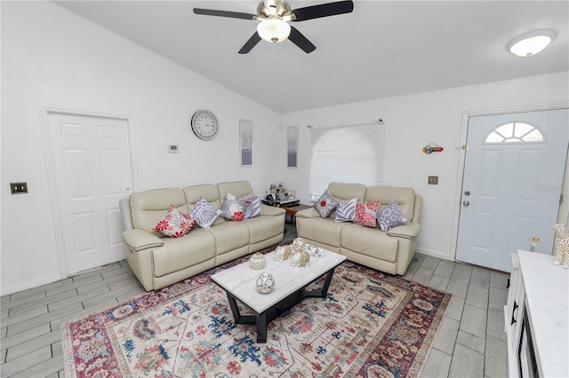 living room featuring vaulted ceiling, ceiling fan, a wealth of natural light, and wood tiled floor