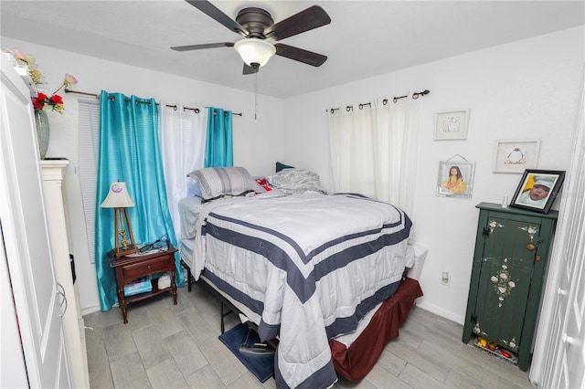 bedroom with light wood-type flooring and a ceiling fan