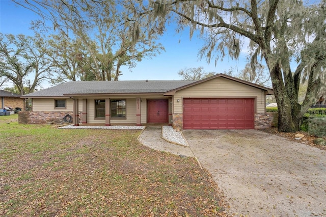 single story home with a garage, stone siding, a front yard, and driveway