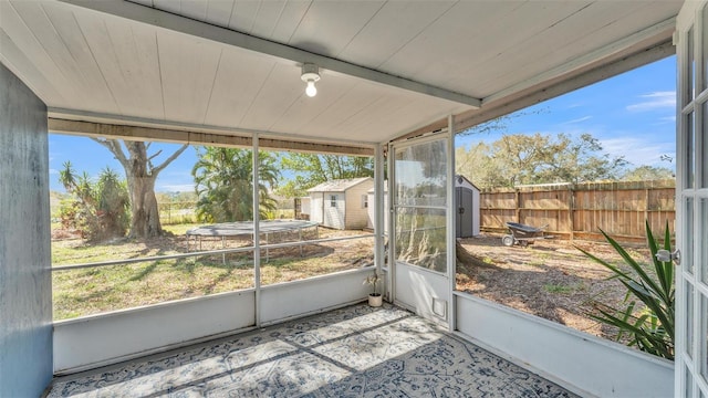 sunroom / solarium with vaulted ceiling with beams, wood ceiling, and a wealth of natural light