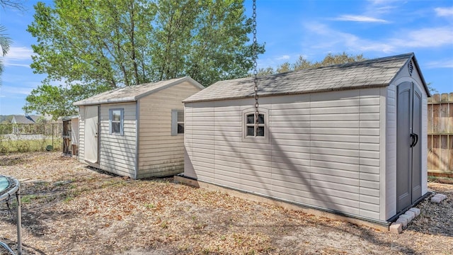 view of shed featuring fence