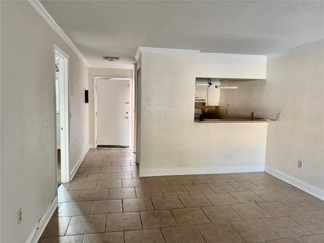 interior space with visible vents, baseboards, a textured ceiling, and ornamental molding