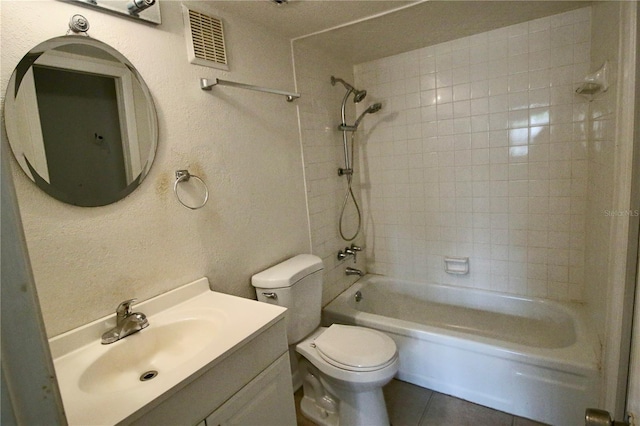 bathroom with visible vents, toilet, bathtub / shower combination, a textured wall, and vanity