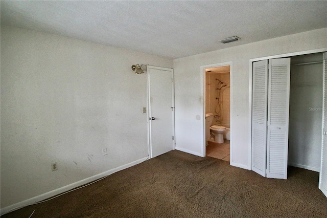 unfurnished bedroom with ensuite bath, visible vents, baseboards, and carpet floors