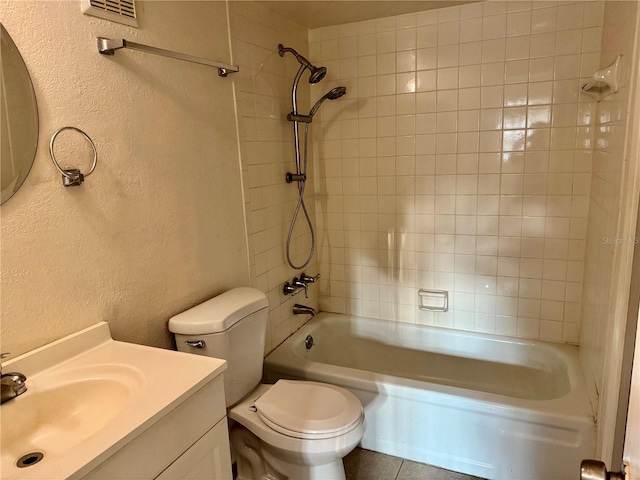 bathroom with visible vents, toilet, shower / tub combination, vanity, and a textured wall