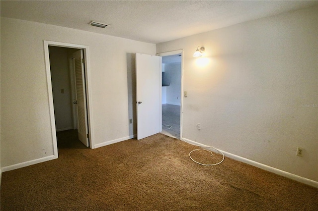 141 Fernery Rd Unit B5, Lakeland, FL 33809 - unfurnished bedroom featuring baseboards, visible vents, and carpet