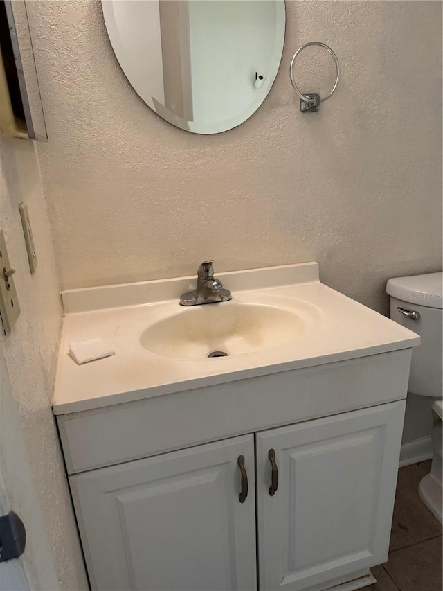 141 Fernery Rd Unit B5, Lakeland, FL 33809 - bathroom with a textured wall, vanity, tile patterned flooring, and toilet