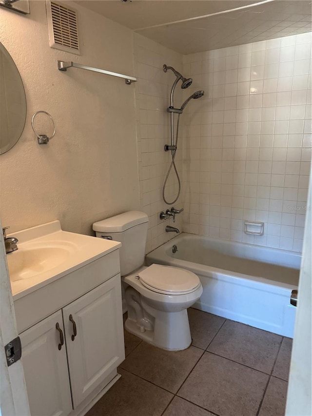 141 Fernery Rd Unit B5, Lakeland, FL 33809 - bathroom with toilet, visible vents, tile patterned flooring, washtub / shower combination, and vanity