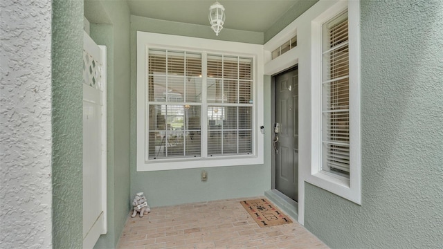 view of exterior entry featuring stucco siding