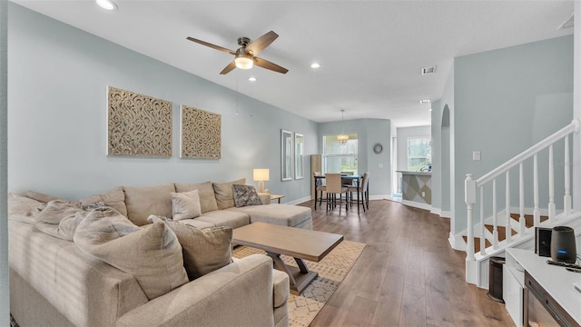 living room featuring stairway, recessed lighting, wood finished floors, and baseboards