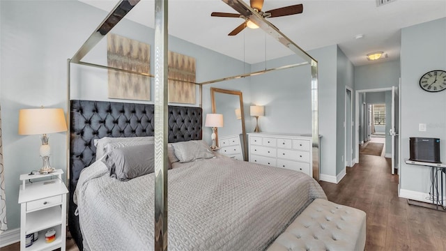 bedroom with baseboards and dark wood finished floors