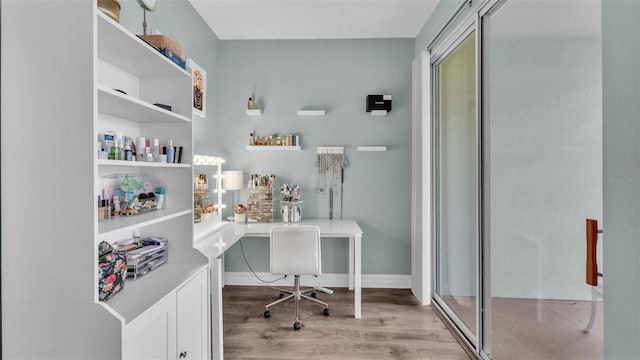 office area with baseboards and light wood-style floors