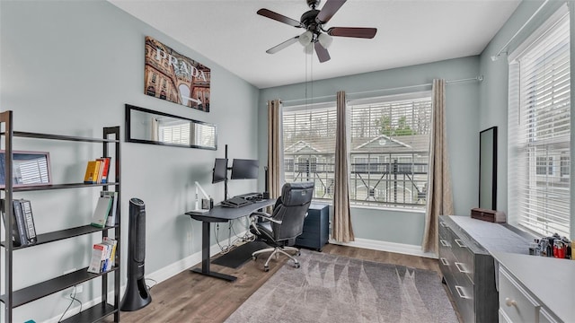 home office featuring ceiling fan, baseboards, and wood finished floors