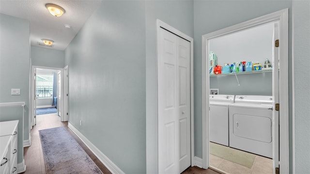 laundry room featuring laundry area, baseboards, and washer and clothes dryer