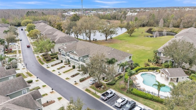 drone / aerial view featuring a water view and a residential view