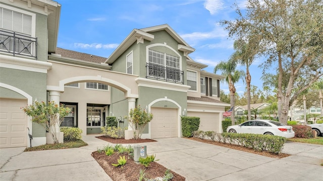 view of front of property featuring a garage, driveway, and stucco siding