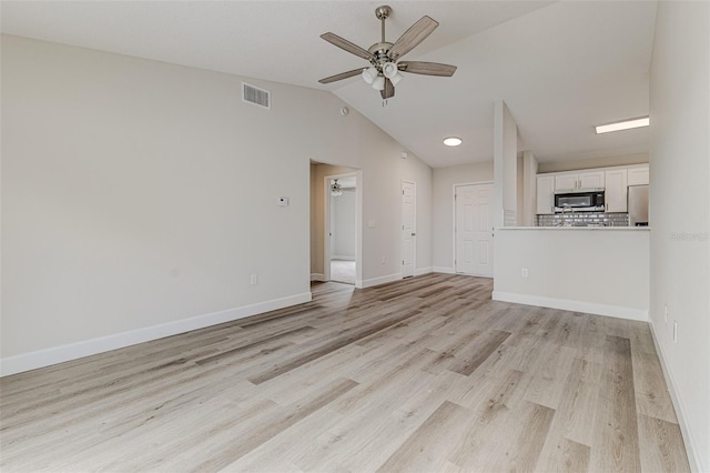 unfurnished living room featuring vaulted ceiling, visible vents, ceiling fan, and light wood-style flooring