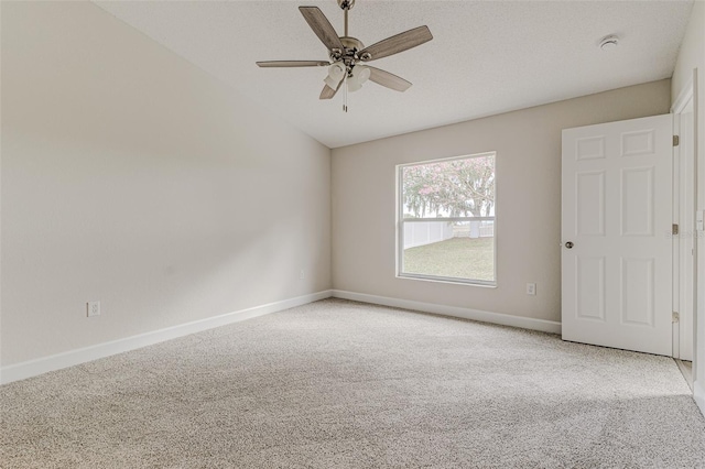 unfurnished room featuring a ceiling fan, light colored carpet, a textured ceiling, and baseboards